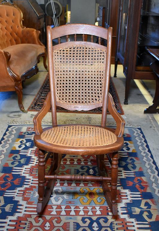 Comfortable Antique Oak Rocker with Caned Back and Seat