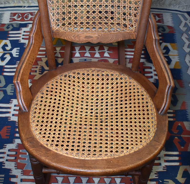 Comfortable Antique Oak Rocker with Caned Back and Seat