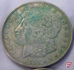(8) 1921 PD or S Morgan silver dollars, all have varying amounts of PVC