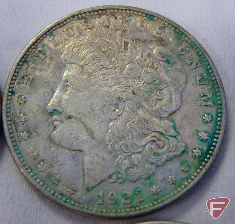 (8) 1921 PD or S Morgan silver dollars, all have varying amounts of PVC