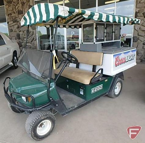 2010 EZ-GO MPT1200 gas utility vehicle with 6-door fiberglass beverage cart body with overhead