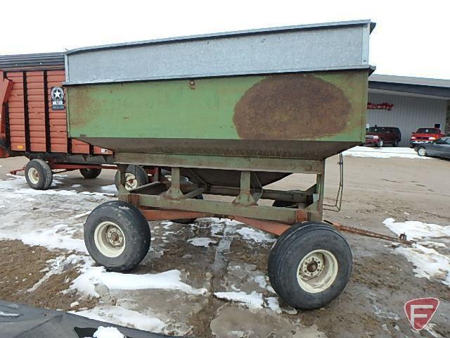 Green gravity box with tank extension on orange running gear with flotation tires