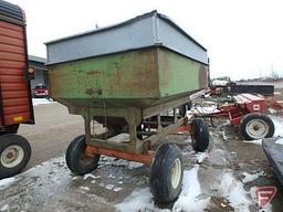 Green gravity box with tank extension on orange running gear with flotation tires