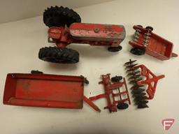 Vintage metal red toy tractor with wagon, and disk no. 9827, manure spreader