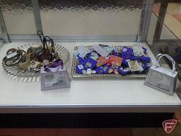 Earrings, bracelets, necklaces, (2) purse hanging sets. All jewelry and trays on bottom shelf