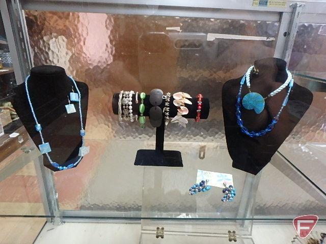 Necklaces, earrings, bracelets on displays. Jewelry and displays