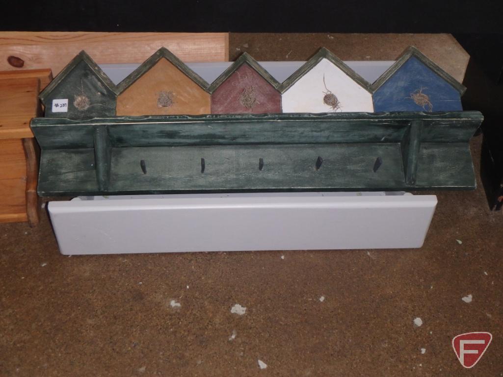 Decorative wood wall shelves, artificial flowers, games, picture frames, books, glass ashtrays,