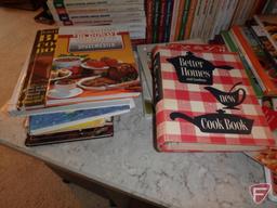 Large assortment of cookbooks.