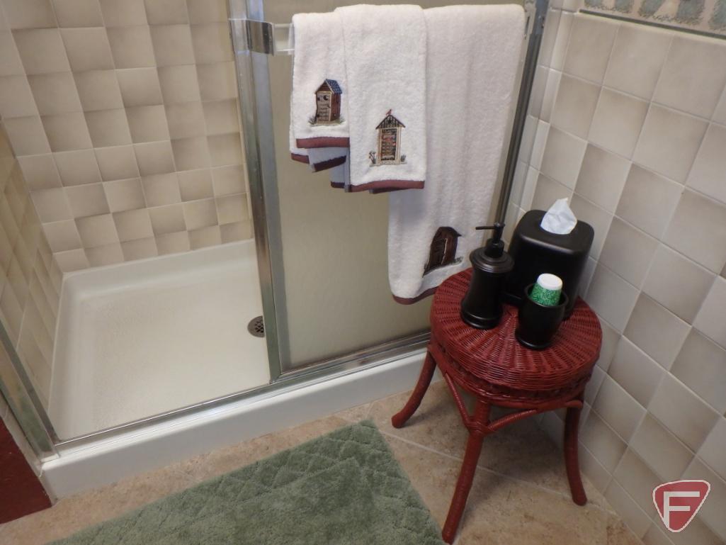Bathroom rugs, wicker stool, metal tissue cover, soap dispenser, and cup holder, candles,