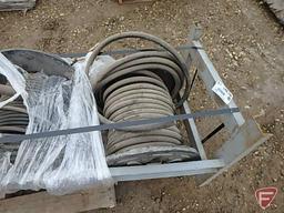 (4) reels of hydraulic hoses on metal frame