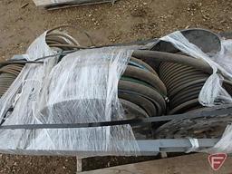 (4) reels of hydraulic hoses on metal frame