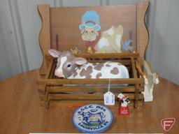 Cow items, print, napkin holder, ceramic figurines, cow bell, and wall decoration. All cow items on