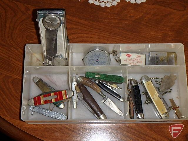 Pocket knives, Peterbilt advertising, watch, Boeing Airlines keychain, and arrowhead