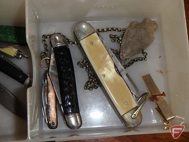 Pocket knives, Peterbilt advertising, watch, Boeing Airlines keychain, and arrowhead