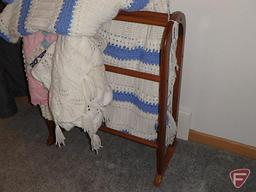 Wood quilt rack with afghans and quilted table runner