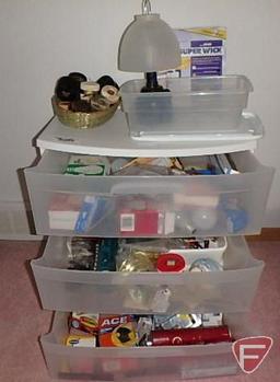 Sterilite 3 drawer plastic organizer with household items: light bulbs, spray bottles,