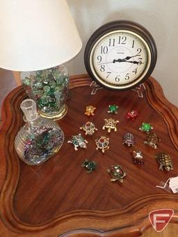 Small ornate turtles, lamp and decorative craft marbles in glass jar and Sharp clock