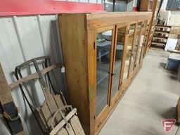 Wood display case with 6 glass doors, 3 drawers, adjustable shelves. One piece unit.
