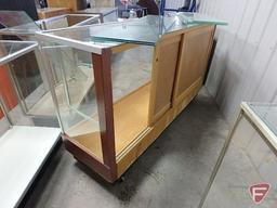 Glass display case, mirrored sliding doors, adjustable glass shelving, on wheels,