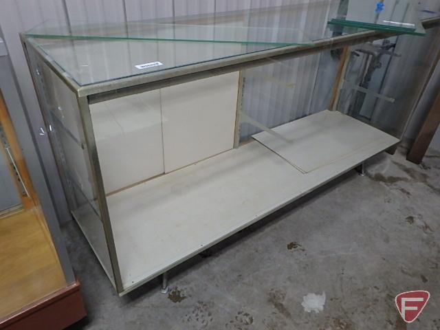 Glass lighted display case, sliding doors, adjustable glass shelving, on metal legs,