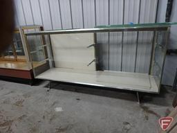 Glass lighted display case, sliding doors, adjustable glass shelving, on metal legs,