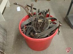 Large plastic bucket of leather horse harness