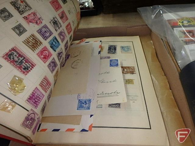 Large collection of stamps, some first day issue in binder, collection of postcards and matchbooks.