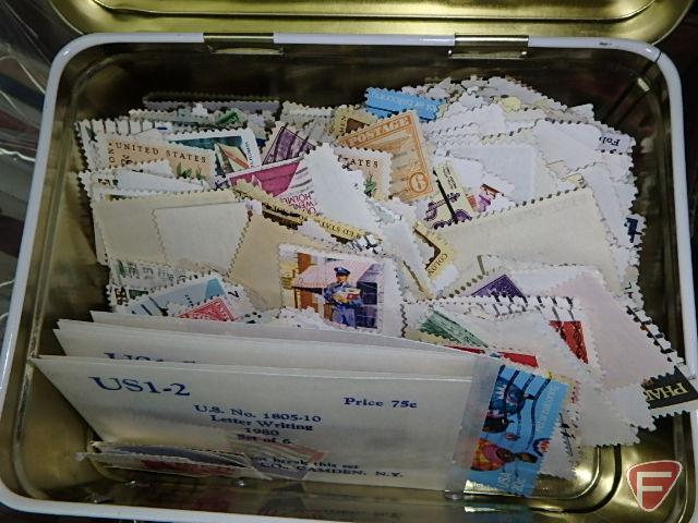 Large collection of stamps, some first day issue in binder, collection of postcards and matchbooks.