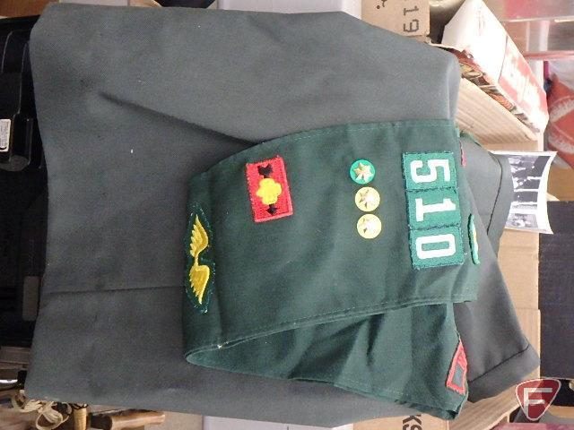 Military jacket, skirt, hat, helmet and Girl Scout sash.