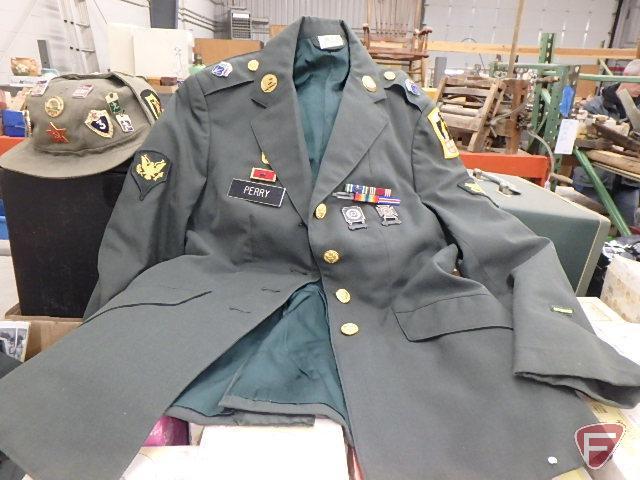 Military jacket, skirt, hat, helmet and Girl Scout sash.