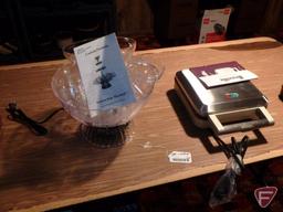 Folding table and contents: New drink/water fountain, Breville pie cooker, ice cream maker,