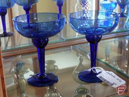 Blue glass vases, stemware, and votive holders, mugs, and brass figurines, candle holders,