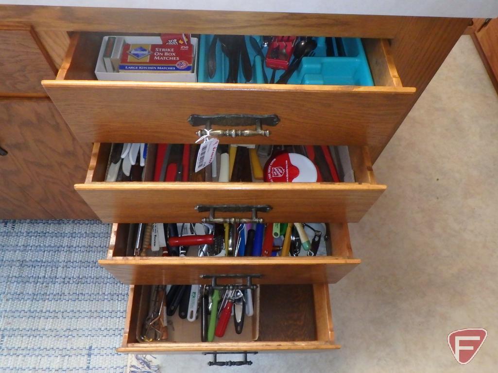 Assortment of silverware, not matching, potholders, knives, kitchen utensils. All 4 drawers