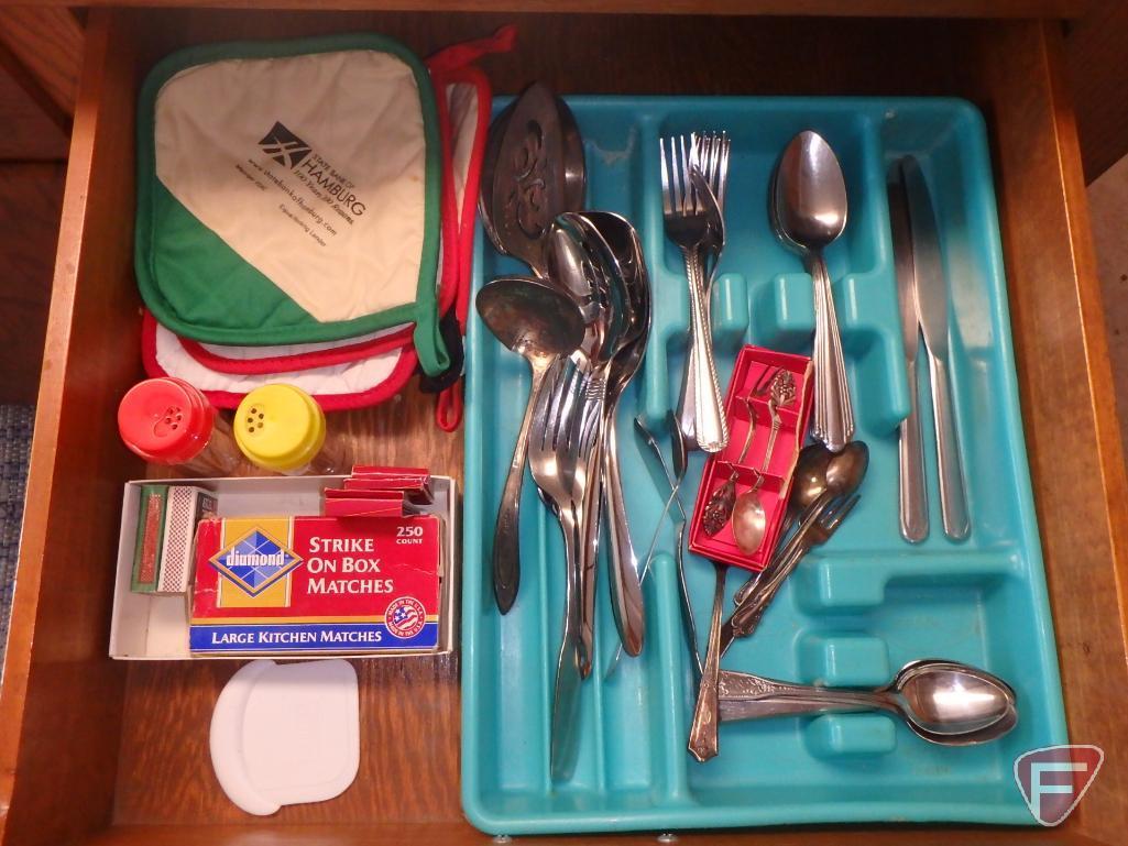 Assortment of silverware, not matching, potholders, knives, kitchen utensils. All 4 drawers