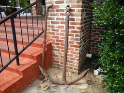 BOAT ANCHOR  LOCATED OUTSIDE, FRONT OF BUILDING