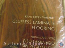 Case of glueless laminate flooring, kane creek walnut. Measuring 50.79X4.96X.47, (8) pieces per box