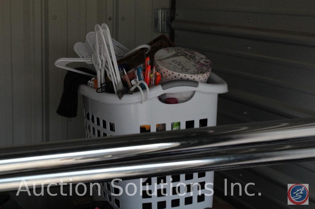 10x10 unit containing luggage, hangers, clothing rack, dog bed, baskets, ladies clothing, plastic