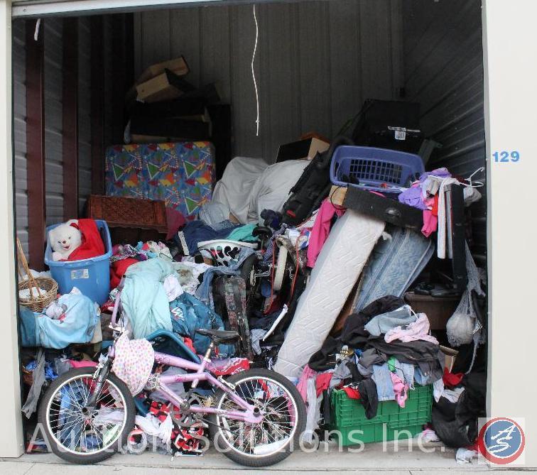 10x10 unit containing children's bicycles, Sanyo flat screen TV, vacuum, luggage, mattress and box