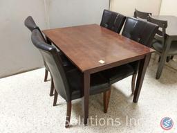 Wood dining table (48x36x30) and (4) black padded chairs {{SOME MATERIAL DAMAGE}}