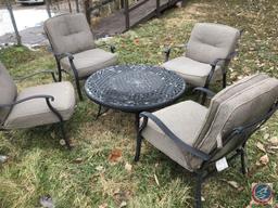 Bistro Set, Outdoor Chairs Windchimes (partially broken) Charcoal Grill, Cinderblock and Board