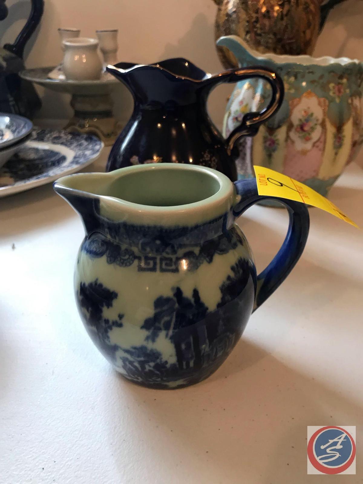 (4) Pitchers Including a Vintage Floral Pitcher, Dark Blue Pitcher, Water Pitcher, and Cream Pitcher