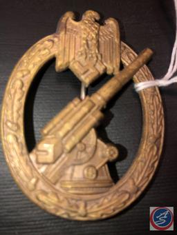 German WWII Army Flak Artillery Badge. The reverse side is maker marked C E Junker Berlin SW. Has a