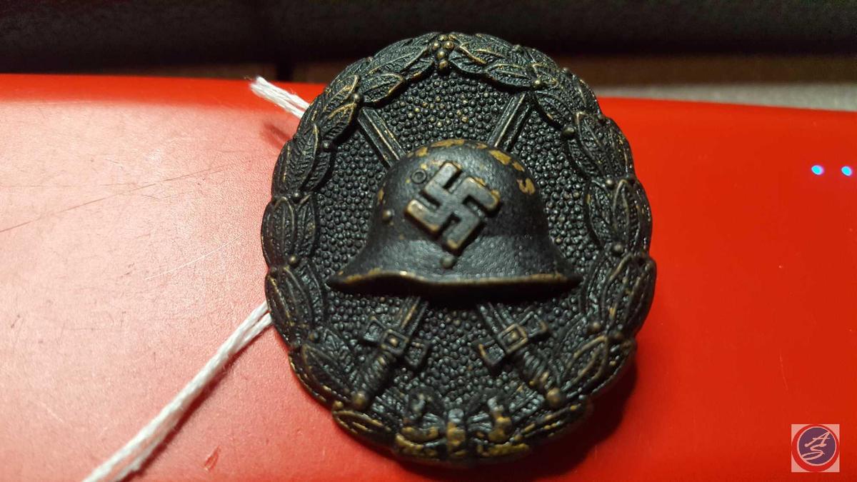 German WWII Black Condor Legion Wound Badge. The front shows a German helmet with a pair of crossed