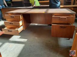 Antique / vintage wood desk with three drawers on the left and two drawers on the right. There is a