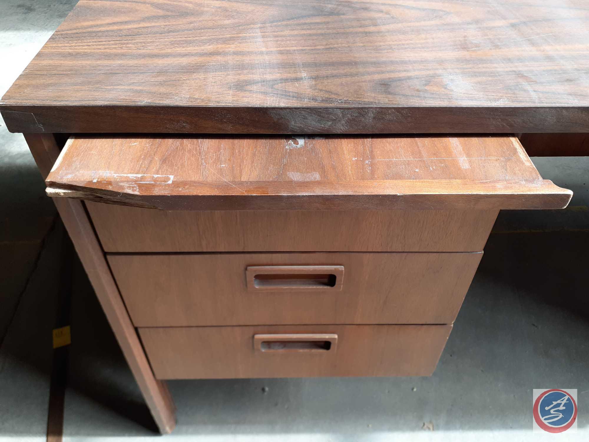 Antique / vintage wood desk with three drawers on the left and two drawers on the right. There is a