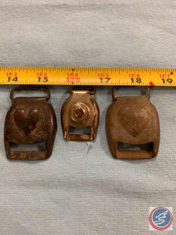 Three harness buckles two with heart stamped one has a circular design