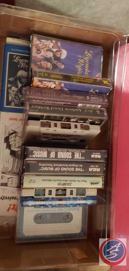Variety of cassette tapes, older model cars and vase...