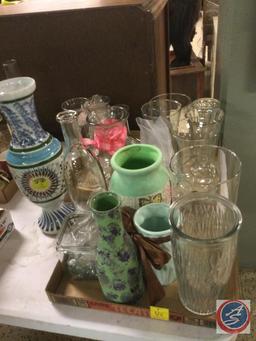 Assortment of clear glass and colored ceramic vases. Also included is a flower frog and flower frog