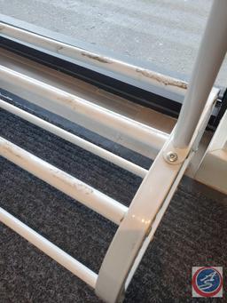 Small metal clothing rack, with lower shelves for shoes. The hangars do have a velvet like material