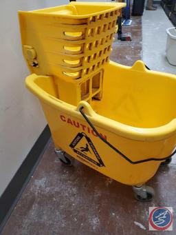 Two Mop buckets, three mop handles, one mop head and a small bucket.... THe bucket is OXO brand and